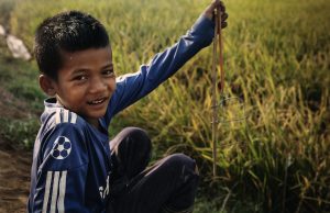 a little boy in the rice fields in Cambodia