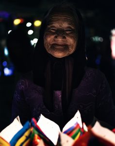 An old lady is selling a lamp in Vietnam