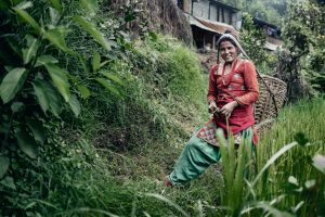 a young lady, working in the rice fields in Nepal